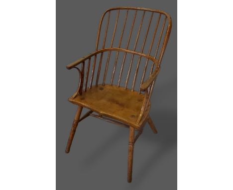 A 19th Century elm Windsor armchair with a stick back above a shaped seat raised upon turned legs with stretchers 