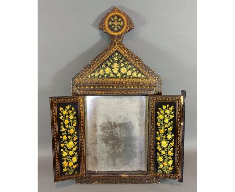 A Persian mirror decorated with figures amongst foliage, 50cms tall