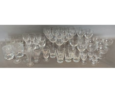 A collection of glassware, mainly drinking glasses