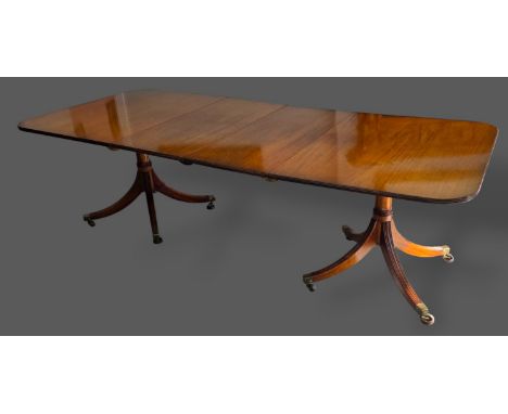 A Regency style twin pillar extending dining table by william Tillman with two extra leaves, 247cms x 107cms fully extended