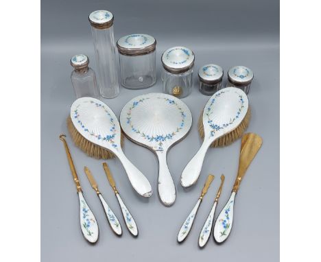 A Birmingham silver and enamel fifteen piece dressing table set comprising a pair of brushes, a hand mirror and six implement