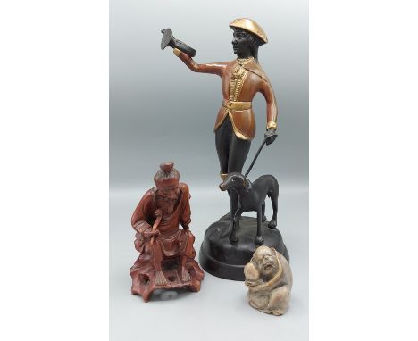 A Patinated metal figure with dog together with a soapstone carving and a root carving in the form of a man with pipe 