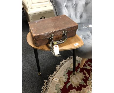 A vintage brown leather suitcase and a lamp table 