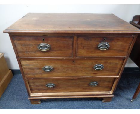 A George III mahogany four drawer chest on bracket feet 