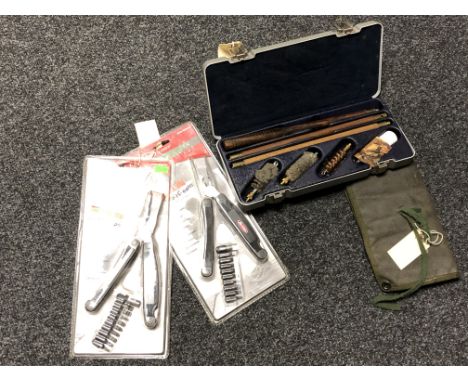 A cased gun cleaning kit, a pouch of gun cleaning accessories and two Berkley Fisherman's Multi Tools, (both new in packaging
