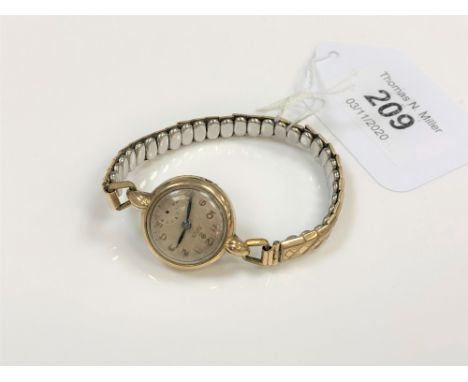 A lady's 9ct gold vintage Tudor wristwatch on plated expanding strap, lacks crown, a/f. 