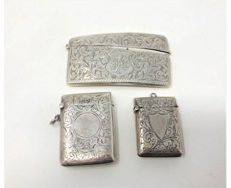 A curved silver card case with engine turned decoration, together with two similar vesta cases. (3) CONDITION REPORT: 88g gro