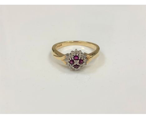 A 9ct gold diamond and ruby cluster ring, size P.