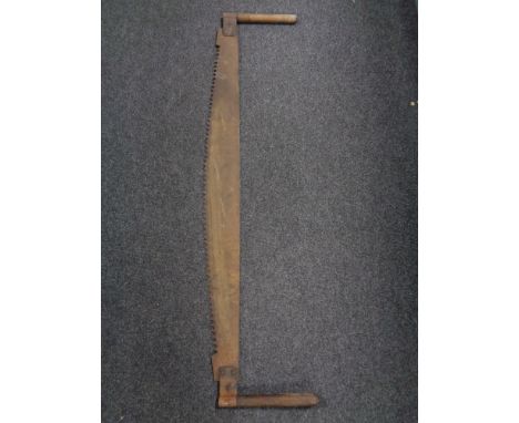 A vintage twin handled cross cut saw