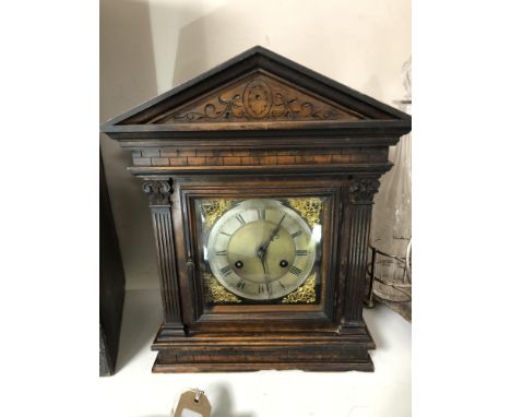 An Edwardian carved pine cased bracket clock with brass and enamelled dial 