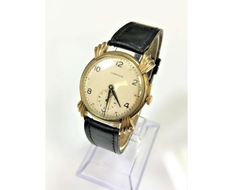 A gent's vintage 9ct gold Longines wristwatch, circa 1945/46, with unusual large, fluted lugs, cream dial with Arabic and dot