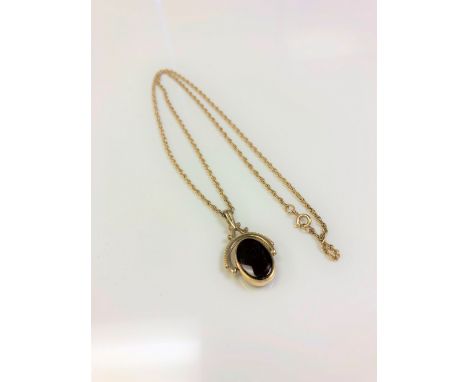 A 9ct gold chain with swivel pendant