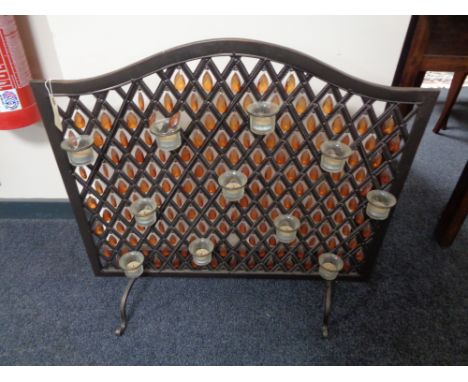 A metal beaded fire screen with eleven light holders 