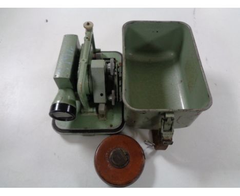 A metal cased surveyor's measure together with a vintage Chesterman leather tape measure 