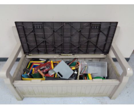 A Keta storage garden bench containing hand tools, power tools, hedge trimmer etc 