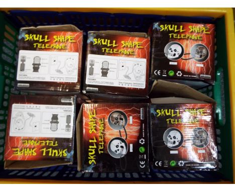 Unused retail stock - twelve skull shaped telephones by  South Sunny with light-up eyes, model No. AR - 5053, all boxed