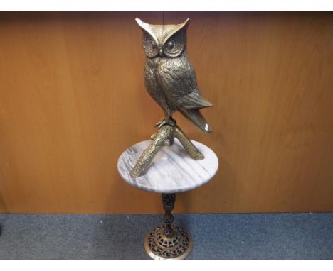 A large brass sculpture depicting an owl with marble topped stand, height of the bird 48 cm (h), height of stand 45 cm (h) (m