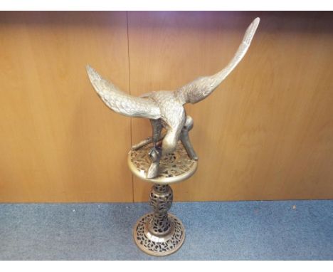 A good quality large brass sculpture depicting a bird of prey with stand, the stand approximately 47 cm (h) and the bird appr