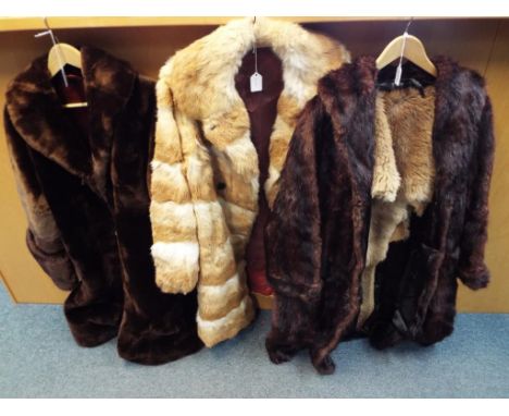 Three fur coats one in dark brown with slip pockets, approximate length 105 cm, one in light brown with two button front and 