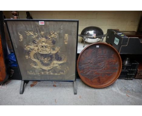 An old firescreen, incorporating a Chinese gilt embroidered panel of a dragon, 46cm wide; together with a Chinese carved hard