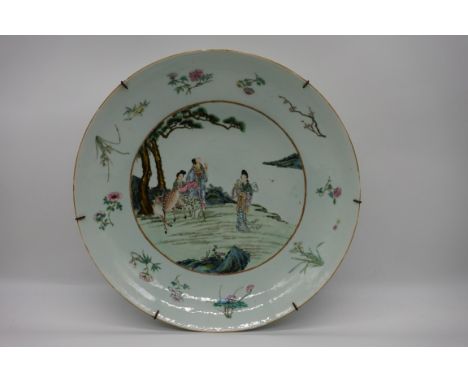 A good and large Chinese famille rose charger, Kangxi six character mark to base, painted with three figures and a deer in a 