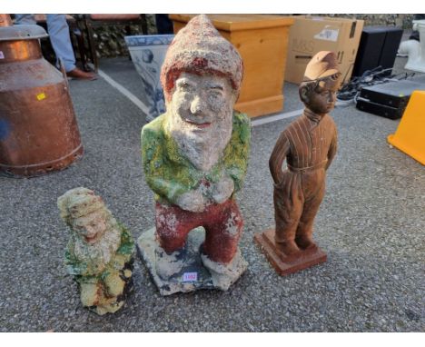 An old painted garden Gnome; together with another smaller example; and a Dutch boy fire implement stand. 