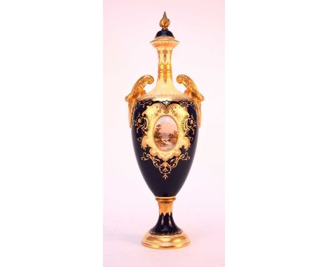 A Coalport vase and cover, circa 1891-1919, of ovoid baluster form with scrolling wreathed twin handles, the cobalt and pale 