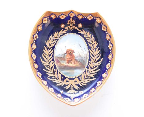 A small and unusual 'jewelled' trinket dish, circa 1885, of shield form, the cobalt ground with a gilt border with white and 