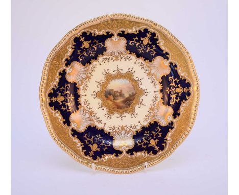 A Coalport dessert plate, circa 1890-1919, centrally painted with a roundel of the Ruins of Brunnenburg, within a tooled gilt