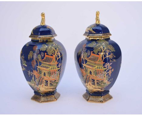 A pair of Carlton Ware Art Deco blue lustre temple vases and covers, chinoiserie decoration, printed factory marks, 25.5cm hi