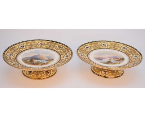 A pair of Coalport low pedestal dessert comport dishes, circa 1880, painted with named views of Dartmouth Castle and Ullswate