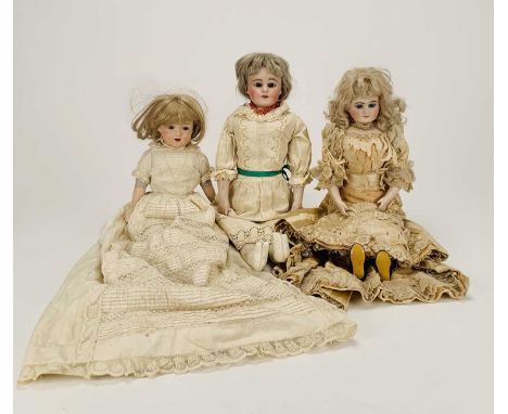 Three German bisque-headed dollsThe first Ernst Heubach, no.7, with blond wig, fixed blue eyes and open mouth with four teeth