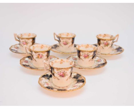 A Coalport dark blue batwing demitasse coffee service, circa 1910, printed and hand-coloured with flowers, comprising six cof
