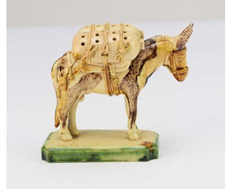 An unusual Continental creamware model of a donkey19th centurydecorated with a Whieldon-type glaze and modelled carrying two 