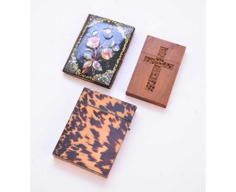 A tortoiseshell card case with metal mounts, together with a carved wood card case depicting a crucifix and a mother of pearl