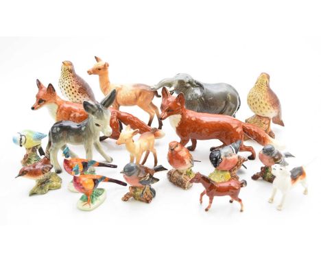 A collection of Beswick wild animals, comprising a pair of medium-size standing foxes, 23cm long; a doe and fawn, an elephant