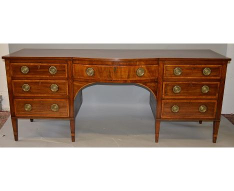 A GEORGE III MAHOGANY AND SATINWOOD CROSSBANDED PEDESTAL SIDEBOARD, with a bow front central drawer, flanked by a drawer and 