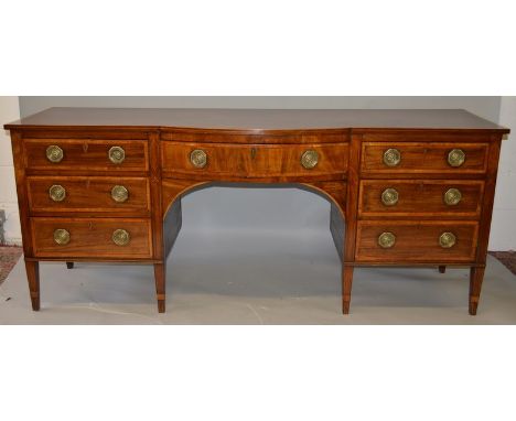 A GEORGE III MAHOGANY AND SATINWOOD CROSSBANDED PEDESTAL SIDEBOARD, with a bow front central drawer, flanked by a drawer and 