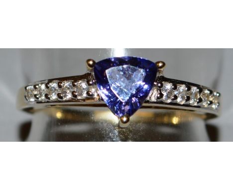 A 9CT GOLD, TANZANITE AND DIAMOND RING.