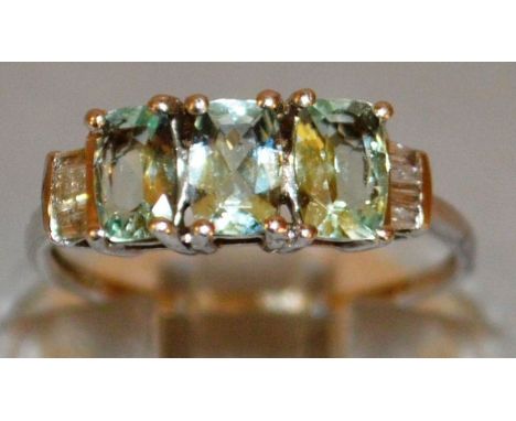 A GOOD THREE GREEN STONE AND DIAMOND RING set in 9ct gold.