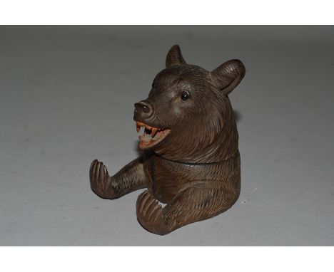 A SMALL CARVED BLACK FOREST BEAR INKWELL. 3.5ins high.