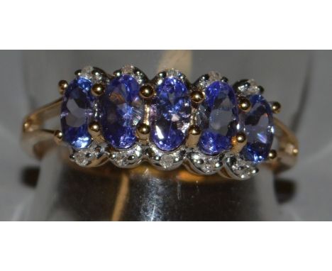 A 9CT GOLD, TANZANITE AND CUBIC ZIRCONIA RING.