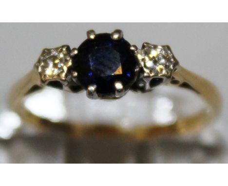 A SAPPHIRE AND DIAMOND THREE STONE RING set in 18ct gold and platinum.