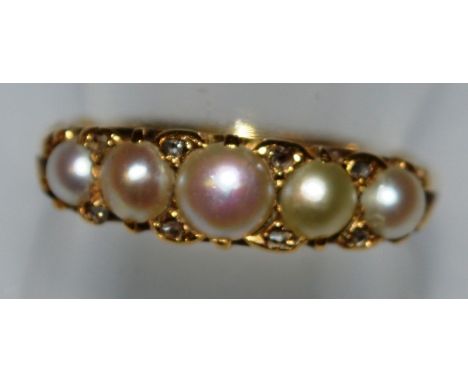 A FIVE STONE PEARL RING set in yellow gold.