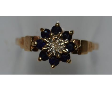 A SAPPHIRE AND DIAMOND CLUSTER RING in 9ct gold.