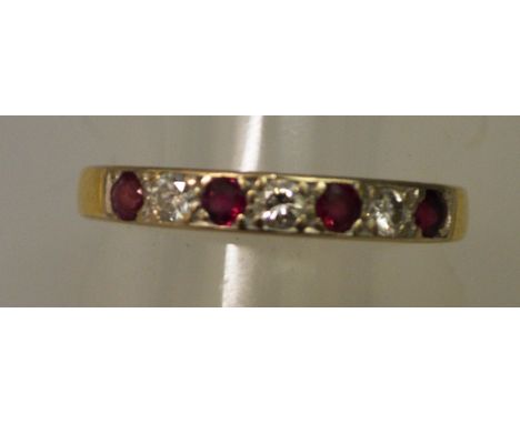 A RUBY AND DIAMOND HALF HOOP RING in 18ct gold.