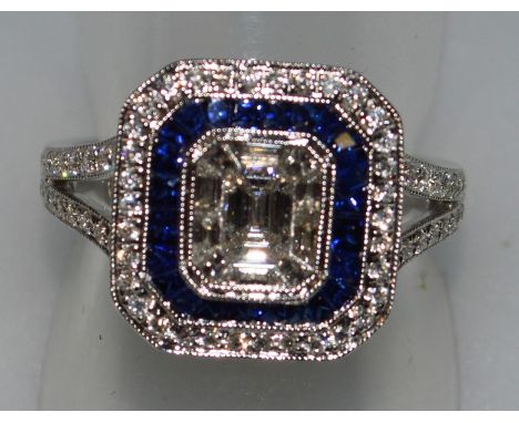 A GOOD SAPPHIRE AND DIAMOND ART DECO DESIGN RING set in 18ct white gold.