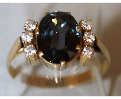 A SAPPHIRE AND DIAMOND CLUSTER RING, central sapphire and six diamonds.