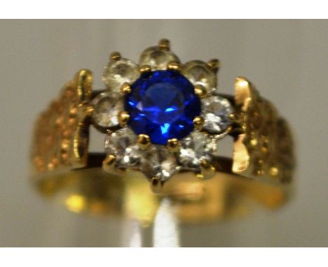 A SAPPHIRE AND DIAMOND CLUSTER RING in 9ct gold.