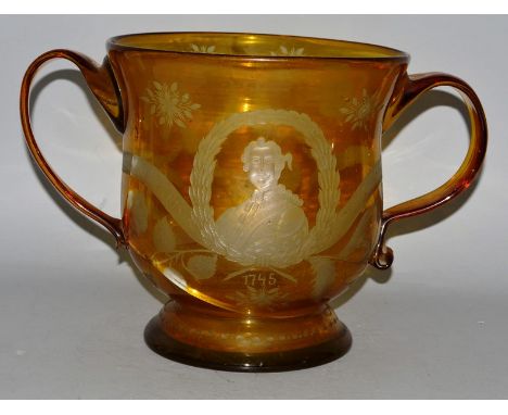AN IMPORTANT PIECE OF SCOTTISH HISTORY (unfortunately damaged), A LARGE AMBER GLASS TWO HANDLED CIRCULAR CUP, fine wheel engr